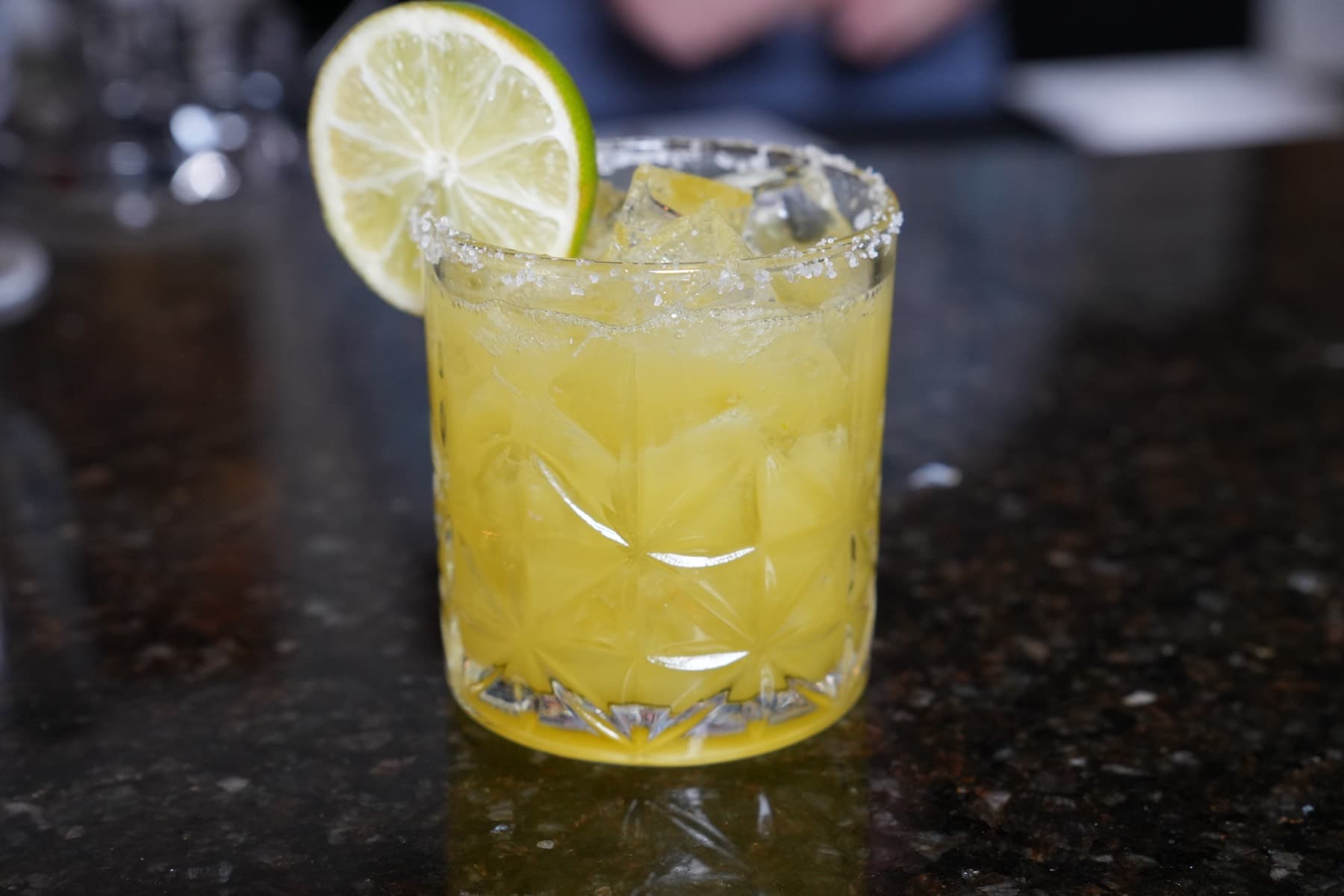 Margarita on the rocks with a salted rim and a fresh lime wheel